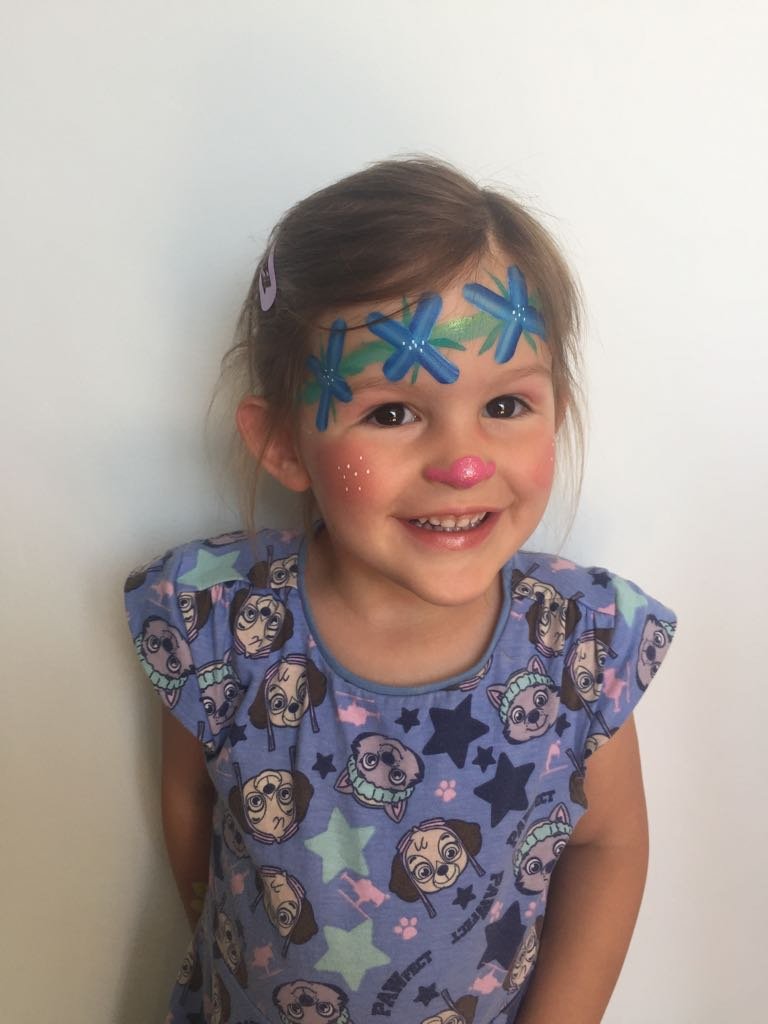 Girl face painted as a cute princess poppy